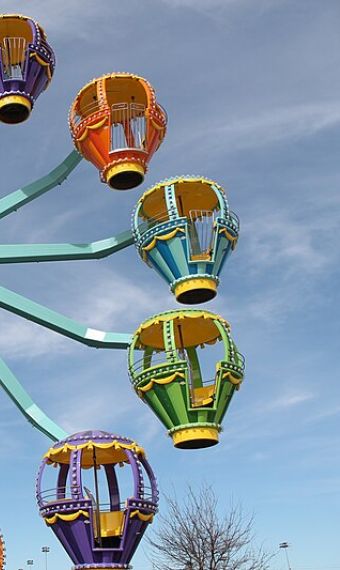Colorful Ferris wheel with multicolored carriages at Morgans Wonderland Amusement Park in San Antonio, TX.