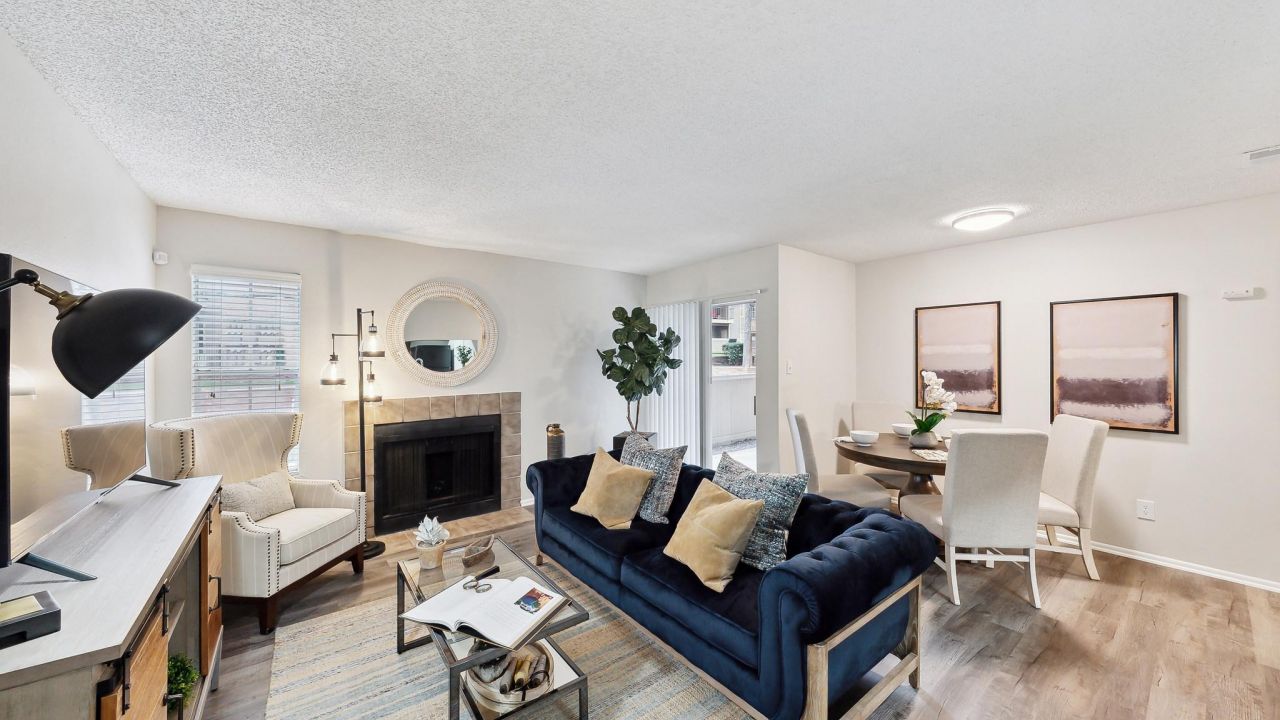 Altamonte Apartments spacious floor plan with fireplace, windows, and access to private outdoor patio.